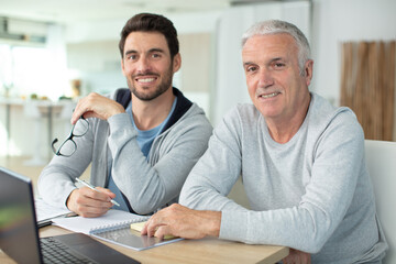 mature male couple using a laptop computer
