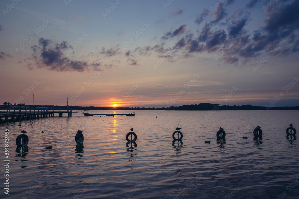 Wall mural Sunset over Narie lake of Ilawa Lake District in Kretowiny, small village in Warmia Mazury region of Poland