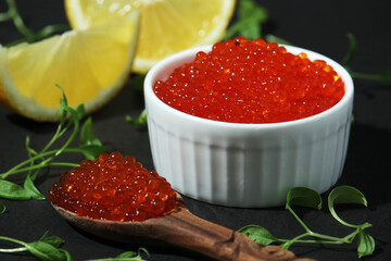 A small ceramic bowl with red caviar