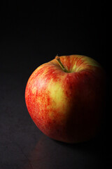 An apple against black background	