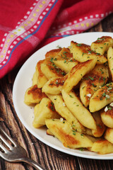 Polish dish kopytka served at the table	