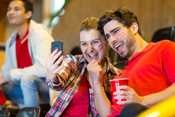 spanish supporters watching football game and making selfie