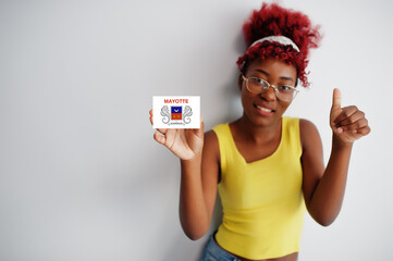 African woman with afro hair, wear yellow singlet and eyeglasses, hold Mayotte flag isolated on white background, show thumb up.