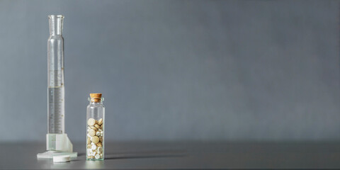 Mix of medical pills in a glass jar on a gray background. Medical and health care concept....
