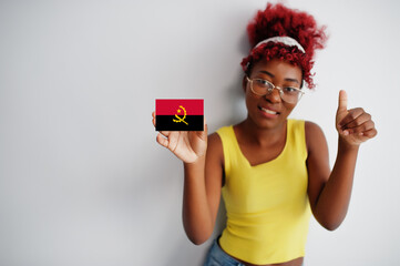 African woman with afro hair, wear yellow singlet and eyeglasses, hold Angola flag isolated on white background, show thumb up.