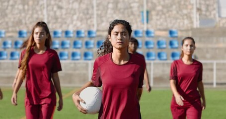 Group of confident female soccer players walking before game - Powered by Adobe