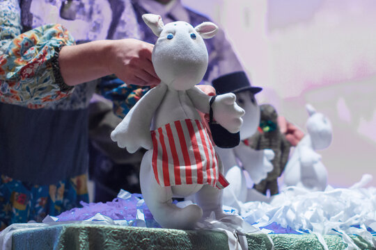 Moscow region / Russia - 01 06 2019: A woman's hand holding a Moomin Troll doll. The actor manages a puppet at a performance in the theater.