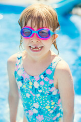 Smiling child with goggles at beach