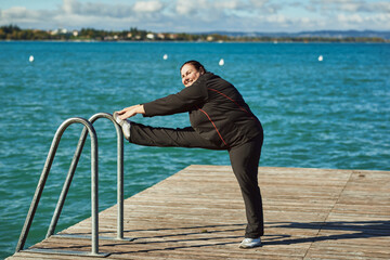 Active senior woman doing healthy exercises outdoors