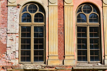 Large old windows of a dilapidated building.