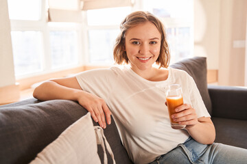 Woman holding a glass of a juice