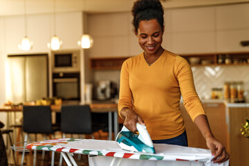 Smiling woman doing house work.