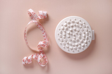 Massage brush and measuring tape. weight loss concept