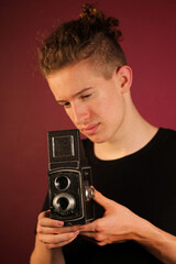 Young photographer with old, retro camera