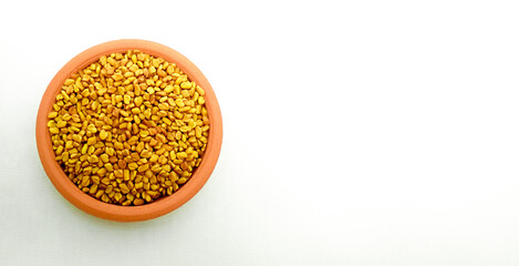 fenugreek or alholva seeds, copy space, white background, top view