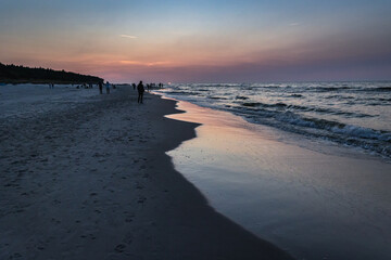 Evening walk on a beach in Debki resort village on the Baltic Sea coast in Pomerania region of Poland