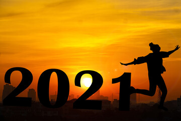 Silhouette  and sunset background.They are standing next to 2021 word.happy new year,love,Success new year.Photo Silhouette and new year. 