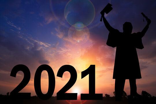 Silhouette  and sunset background.They are standing next to 2021 word.happy new year,love,Success new year.Photo Silhouette and new year. 