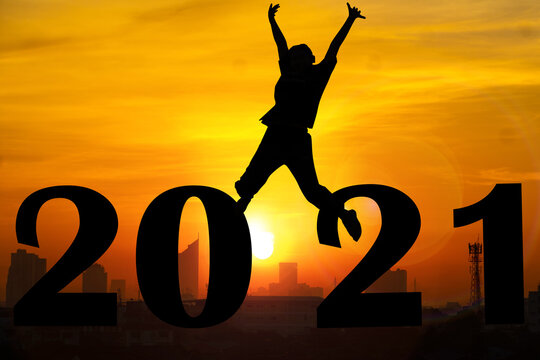 Silhouette  and sunset background.They are standing next to 2021 word.happy new year,love,Success new year.Photo Silhouette and new year. 