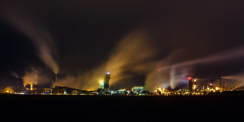 Naklejka na ściany i meble night industrial landscape environmental pollution waste of thermal power plant. Big pipes of chemical industry enterprise plant