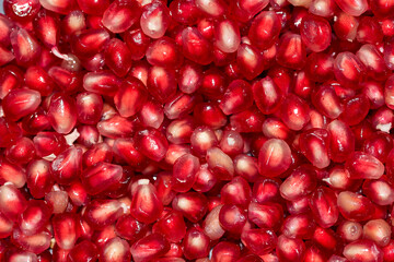 Red pomegranate close-up, juicy red fruit ready to eat, healthy food, fruit full of vitamins.