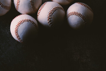 Group of baseballs for sport in low key lighting on black background close up.