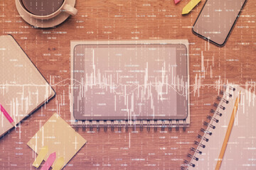 Double exposure of forex chart hologram over desktop with phone. Top view. Mobile trade platform concept.