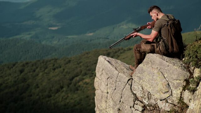 Hunter man. Hunting period, autumn season. Guy with gun. A hunter with a hunting gun and hunting form to hunt in an autumn forest.
