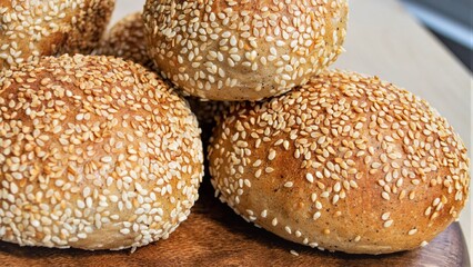 Composition in natural light. Homemade rye German buns with sesame seeds. Close-up