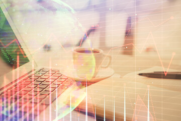 Double exposure of financial chart drawing and desktop with coffee and items on table background. Concept of forex market trading