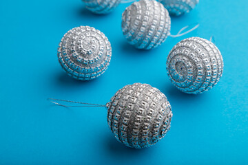 Christmas or New Year composition. Decorations, silver balls, on a blue background. Side view.