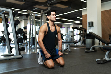 Hispanic man sitting and resting at the fitness club