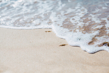 Soft blue ocean wave on sandy beach. Background.