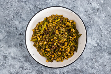 plant-based food, vegan curry with yellow split peas green beans and onions topped with flax seeds