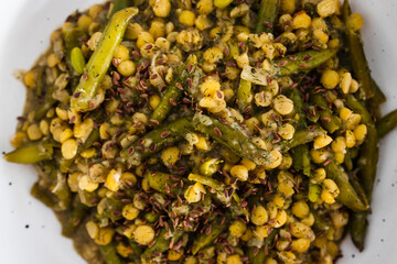 plant-based food, vegan curry with yellow split peas green beans and onions topped with flax seeds