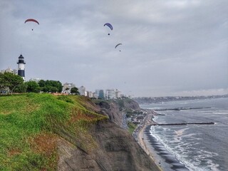Fototapeta na wymiar Pacific Ocean - Paragliding - Miraflores, Lima, Peru. One of the most affluent districts that make up the city of Lima. It has various hotels, restaurants, bars, nightclubs, and department stores.