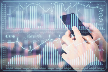 Double exposure of man's hands holding and using a digital device and forex graph drawing. Financial market concept.