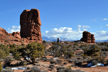 The Balanced Rock formation and white mountains in the background, Arches National Park, Moab, Utah