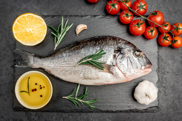 Raw dorado fish with spices on a stone background 