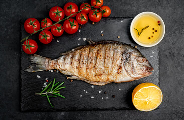 grilled dorado fish with spices on a stone background 