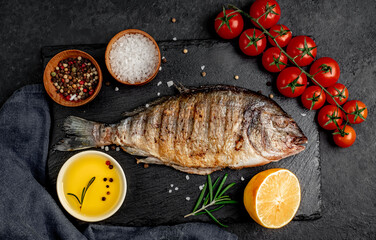 grilled dorado fish with spices on a stone background 