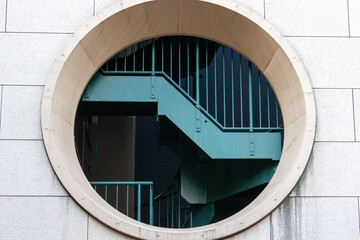 Fototapeta premium Round window and staircase photographed from the outside