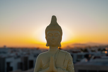 Buddha or Buda statue with sunrise or sunset at golden hour
