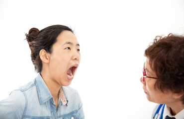 The dentist is treating a female patient's teeth