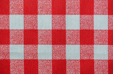 Red tablecloth texture, close-up. Checkered pattern fabric.