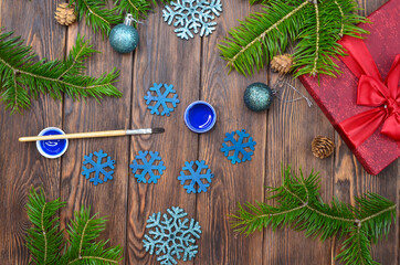 new year's creativity, preparation for Christmas, drawing with a brush and acrylic paints wooden decorat home on the table top view