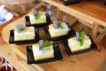 Slice of delicious vanilla cake on wooden table.