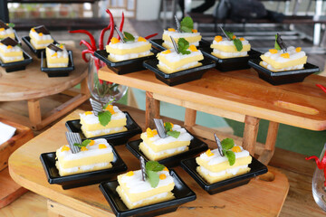 Slice of delicious vanilla cake on wooden table.