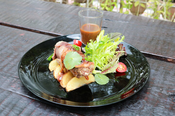 Beef Patty and suki steak in black plate.