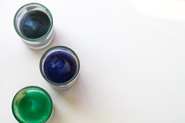 Colored water in glasses on a white background. Alcohol of different colors.